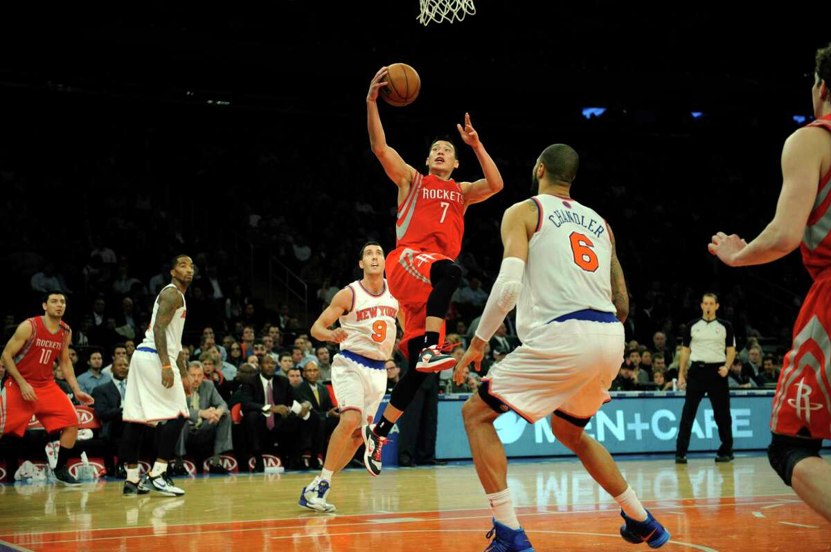 4256 x 2832~~$~~Houston Rockets' Jeremy Lin, center, scores two of his 22 points on New York Knicks' Pablo Prigioni, left, and Tyson Chandler in the third quarter of the NBA basketball game at Madison Square Garden in New York, Monday, Dec. 17, 2012. Houston won 109-96. (AP Photo/Henny Ray Abrams)