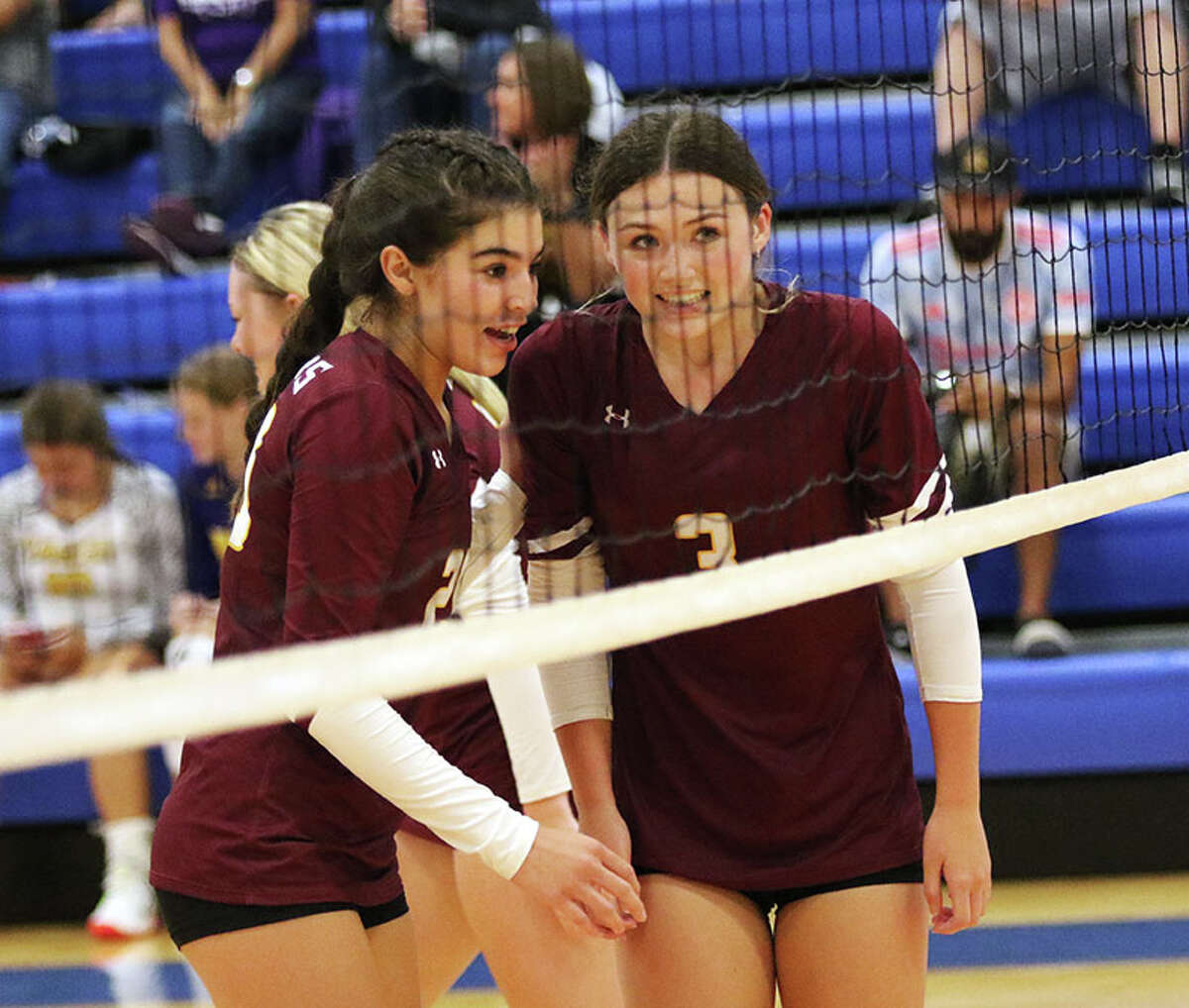 EA-WR's Violet Stover (right) and Kenadie Romero wait for a serve in a match at the Roxana Tourney in August. On Monday, the Oilers were home in Wood River and defeated Father McGivney in two sets.
