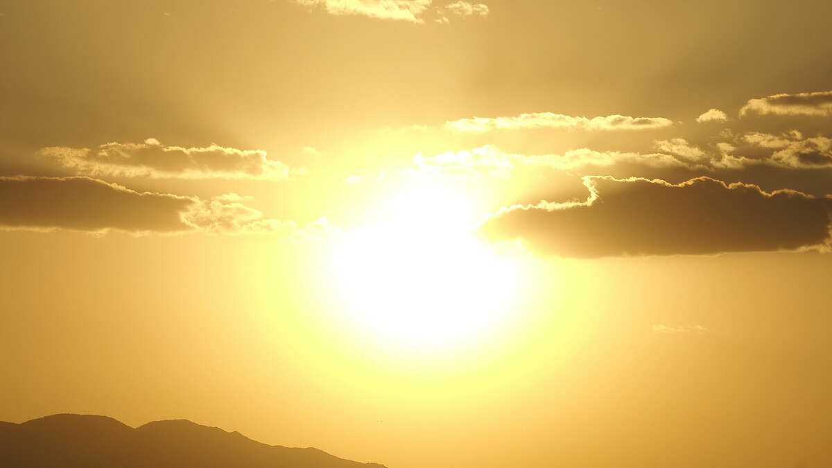 A composite image of the blazing sun bursting with light over the Sonoran Desert of Phoenix, Ariz.
