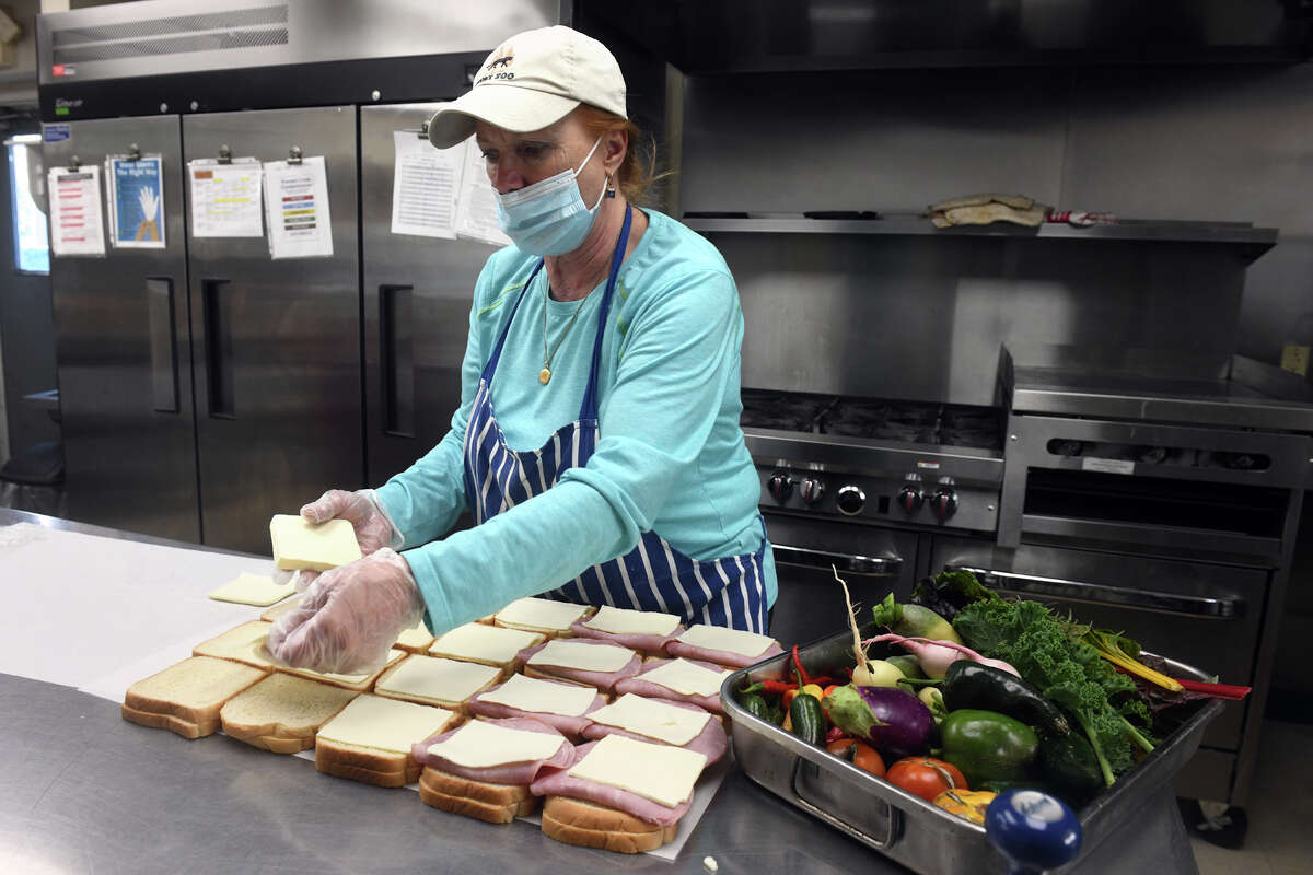 Soup kitchen manager Carolyn Miller prepares sandwiches in the kitchen at the Beth-El Center, in Milford, Conn. Oct. 10, 2022.
