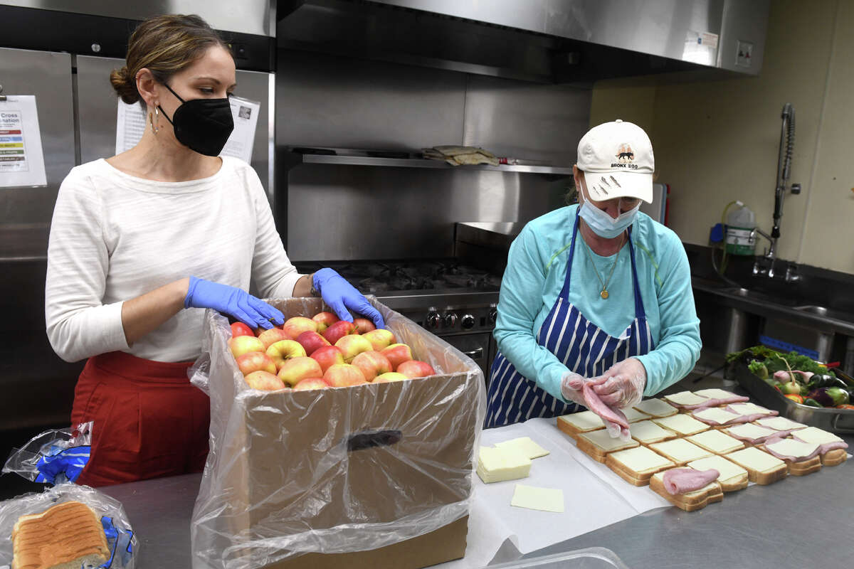 Executive Director Jennifer Paradis, left, speaks with soup kitchen manager Carolyn Miller as she prepares sandwiches in the kitchen at the Beth-El Center, in Milford, Conn. Oct. 10, 2022.