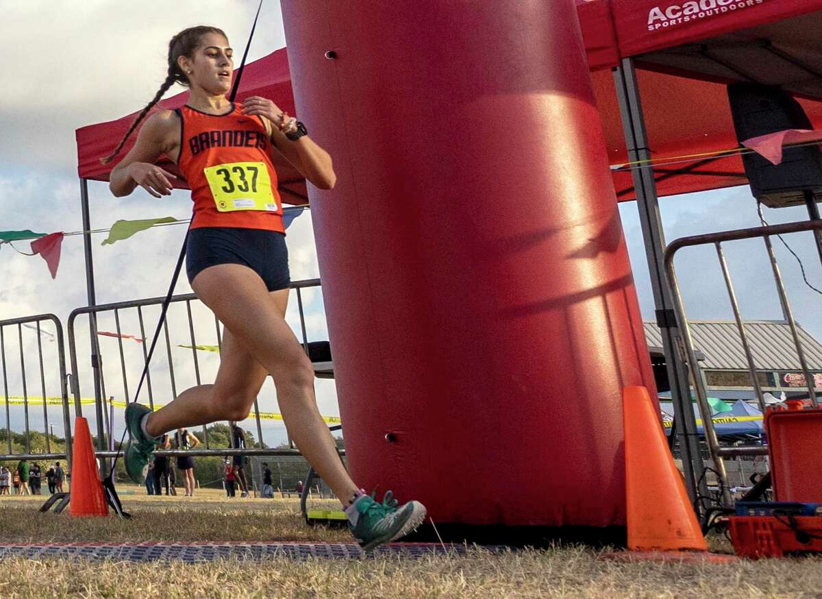 Brandeis’ Mikaela Garza crosses the finish line Tuesday in the District 28-6A cross country championships at the North East Sports Park. Garza finished first with a time of 18:56.6.