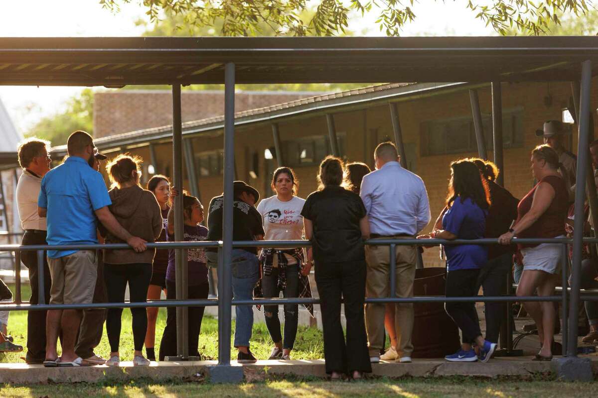 An overflow of people stand outside the Uvalde Consolidated Independent School District board room, which quickly reached its limit of 90 people at a meeting Monday.