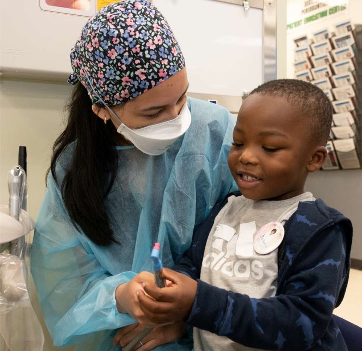 An SIU SDM dental student provides free dental care during the SIU SDM’s Give Kids a Smile Day on Monday.  