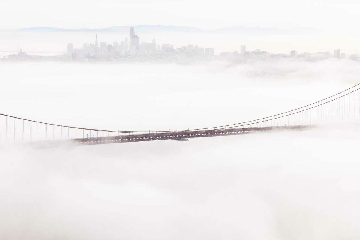 The Golden Gate Bridge is seen surrounded by a layer of fog in Sausalito on March 2, 2022.
