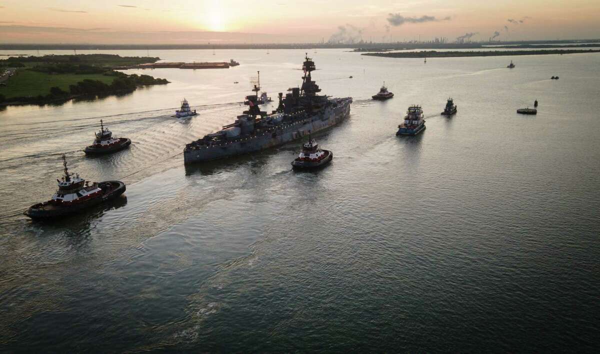 The Battleship Texas is towed into the Houston Ship Channel as it makes its way to Galveston for repairs Wednesday, Aug. 31, 2022, in La Porte.