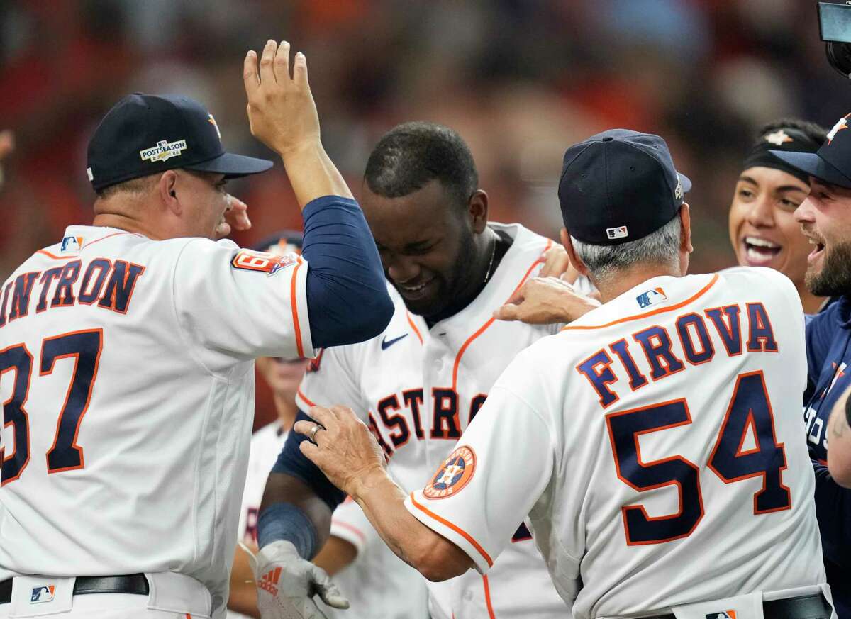 Houston Astros left fielder Yordan Alvarez (44) is mobbed by coaches and teammates after his walkoff homer to beat Seattle in Game 1 of the ALDS.
