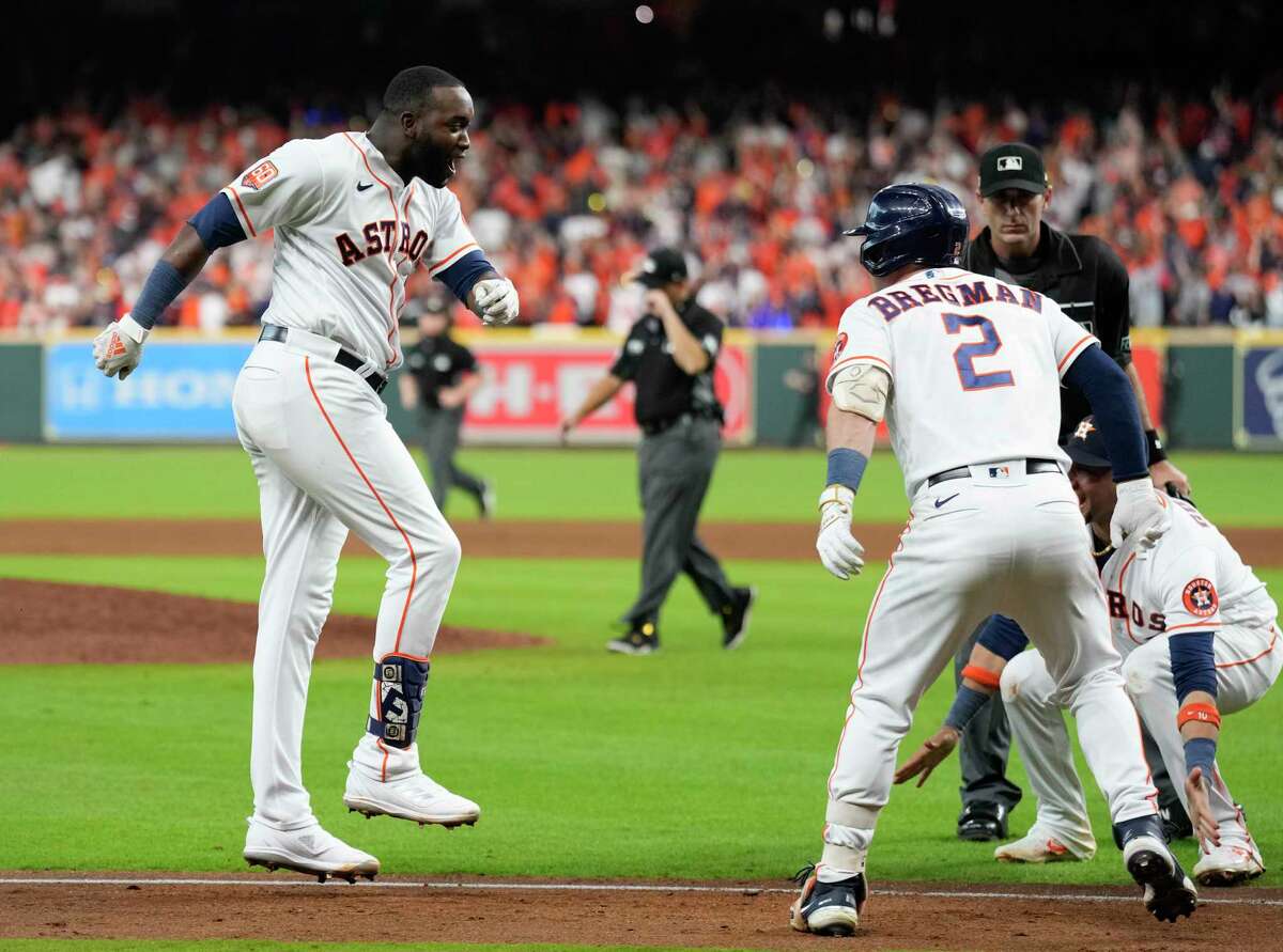 Yordan Alvarez gets set to cross home plate as his teammates wait to greet him following his stunning three-run, walkoff homer to beat the Mariners in Game 1 of the American League Division Series on Tuesday at Minute Maid Park.