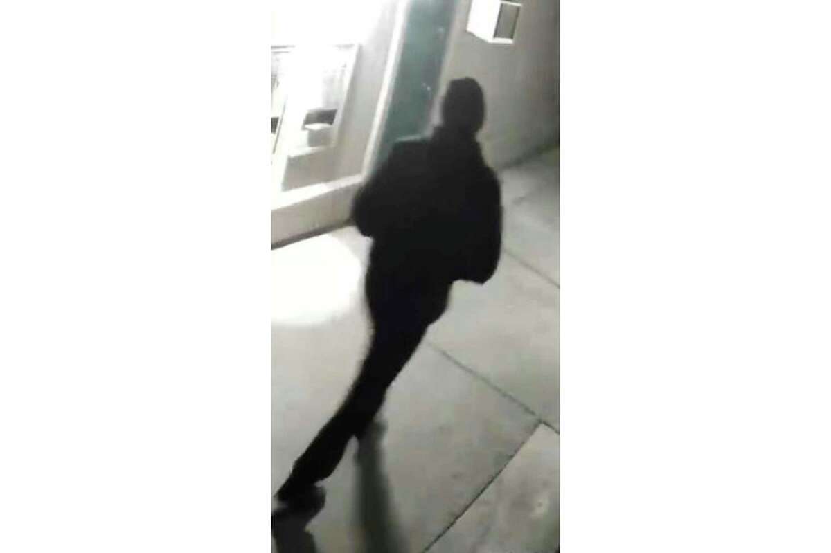 In this undated surveillance image released by the Stockton Police Department, a “person of interest” is seen dressed in black and wearing a black cap. Ballistics tests have linked the fatal shootings of six men and the wounding of one woman in California.