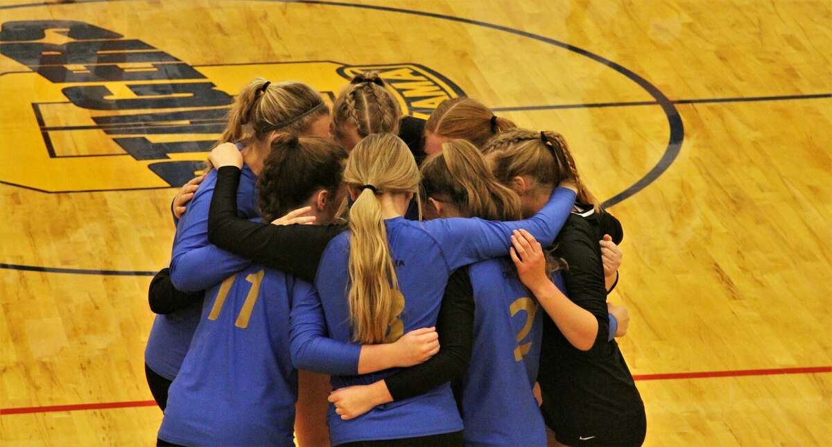 The Onekama volleyball teams huddles before a match against Benzie Central on Oct. 11 at Onekama High School. 