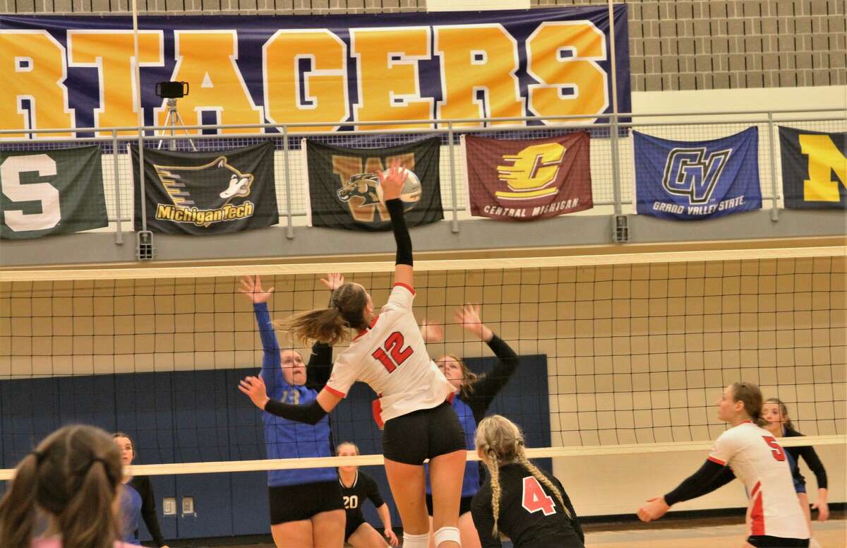 Benzie Central junior Ava Bechler places the ball over Onekama's front line on Oct. 11 at Onekama High School. 