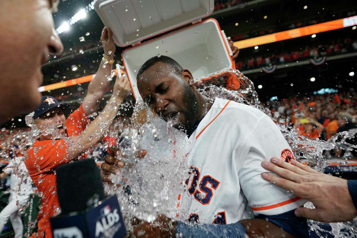 Houston Astros left fielder Yordan Alvarez is doused by teammates after his three-run, walk-off home run beat the Seattle Mariners 8-7 in Game 1 of their ALDS.