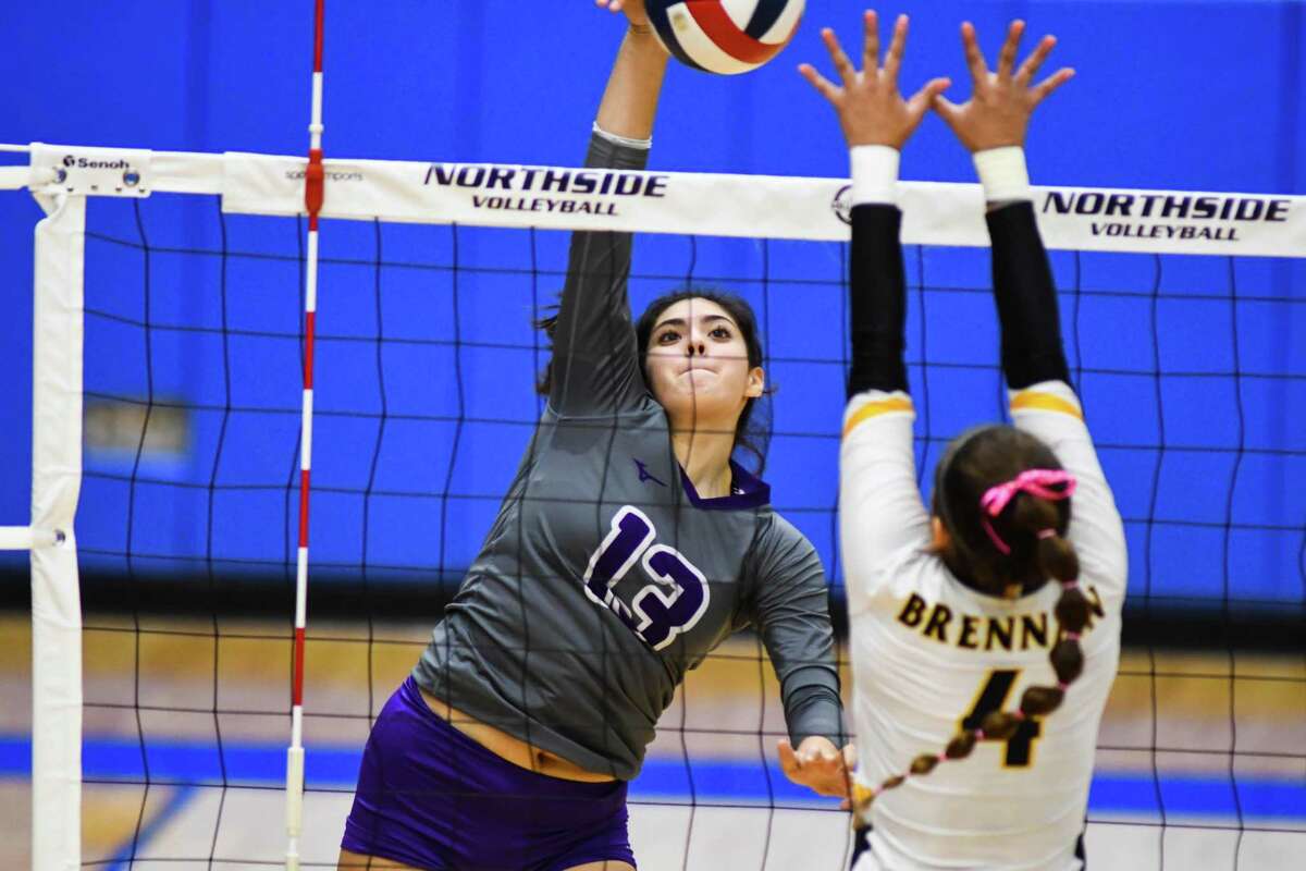 Warren’s Sophia Rodriguez spikes the ball during the second set in Tuesday’s district volleyball game against Brennan at Northside Sports Gym.