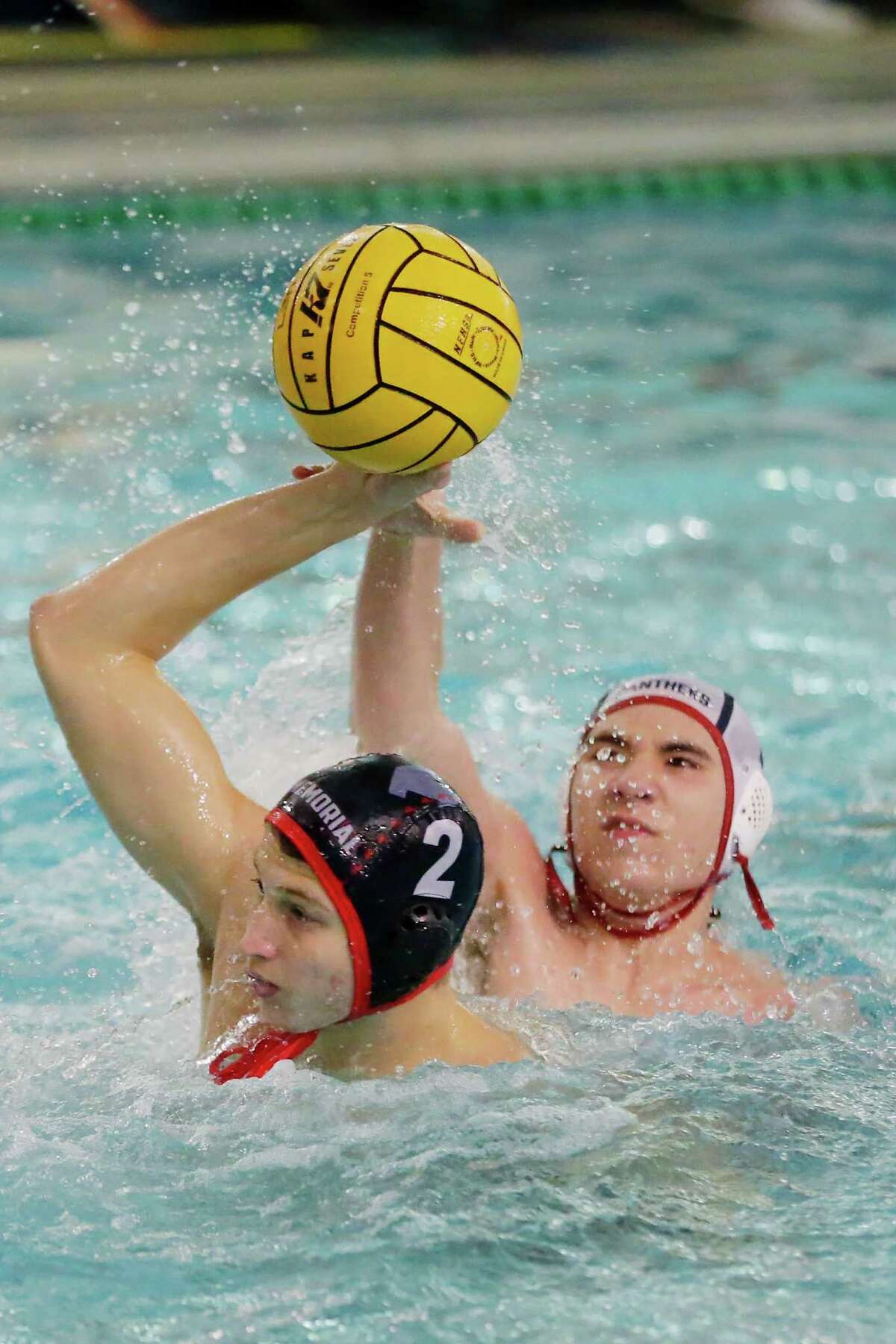 Memorial’s Romain Joubert (2) attempts to pass the ball as Cy-Springs’ Logan Drury, right, reaches in to break up the play during their Region II-Conference 6A Bi-District State waterpolo playoff match, held at the Spring Branch ISD Natatorium Tuesday, Oct. 11, 2022 in Houston, TX.