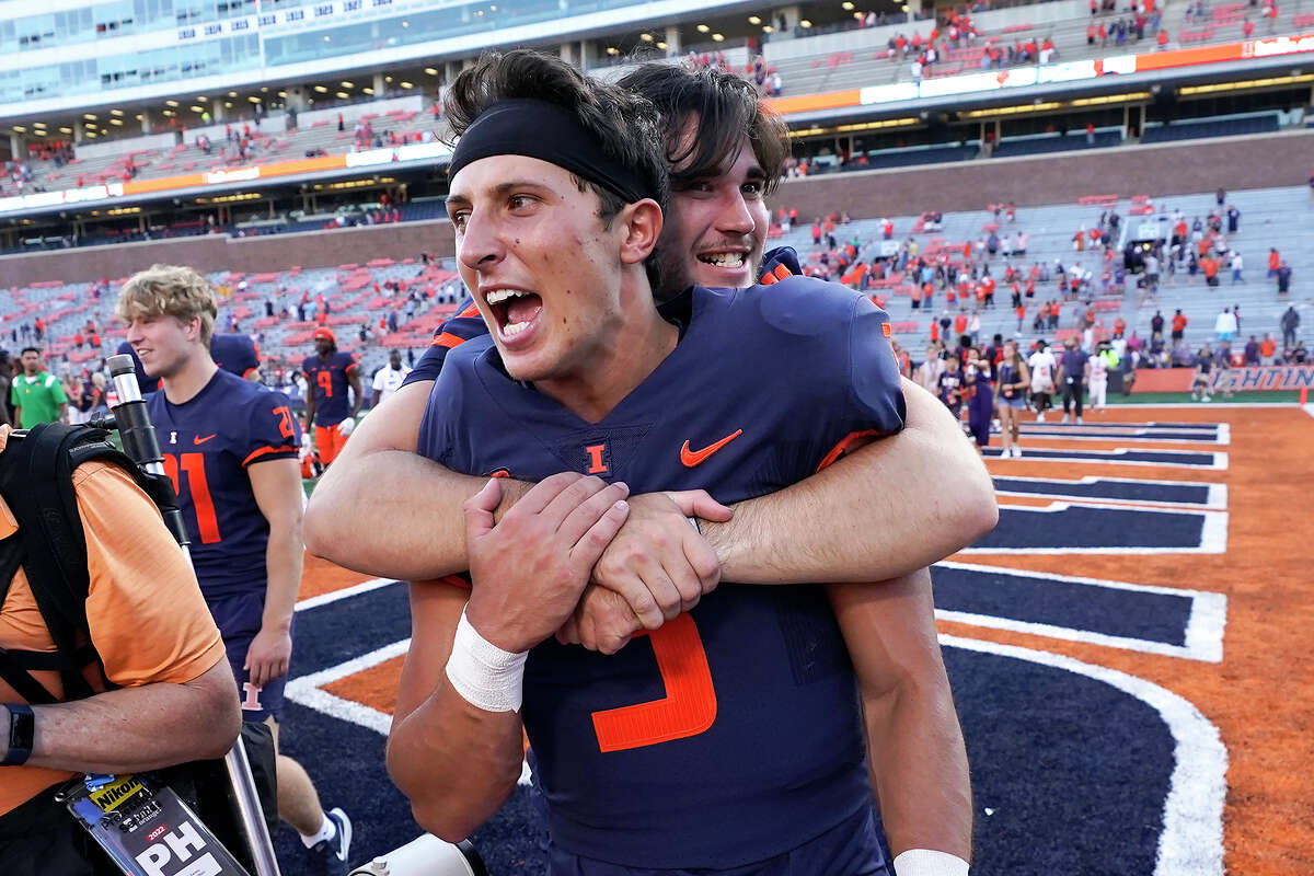 Illinois quarterback Tommy DeVito is hugged by a teammate after a win over Wyoming. Illinois is the most surprising team and quarterback Tommy DeVito is the most surprising player in the Associated Press Big Ten Midseason Awards.
