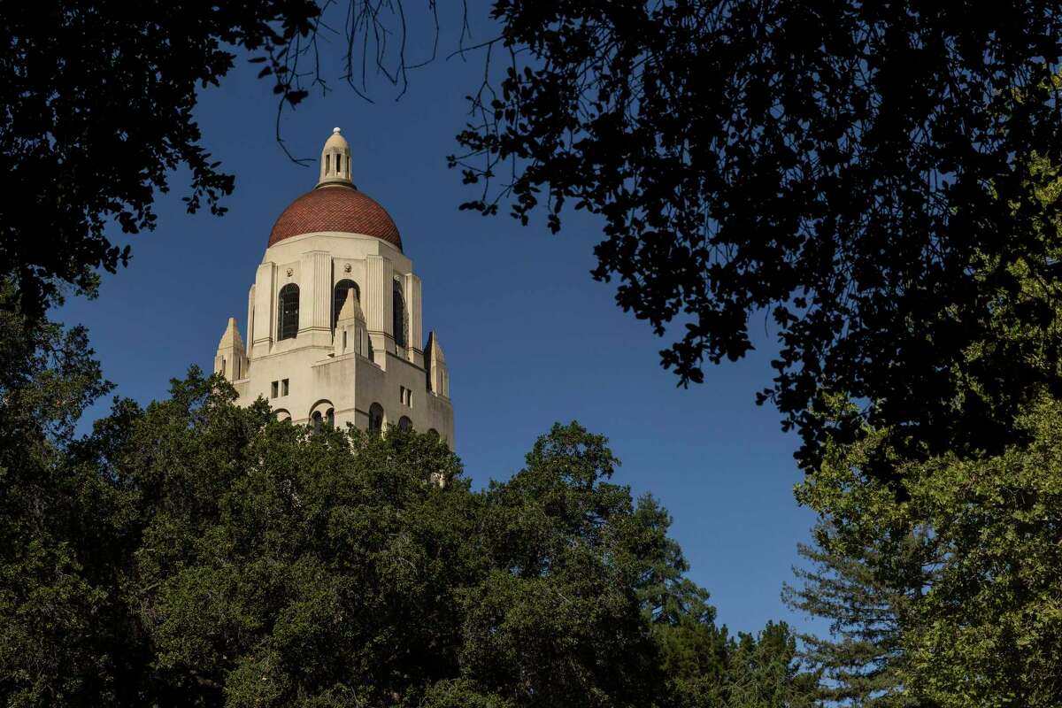 Hoover Tower is seen through the trees at Stanford University.