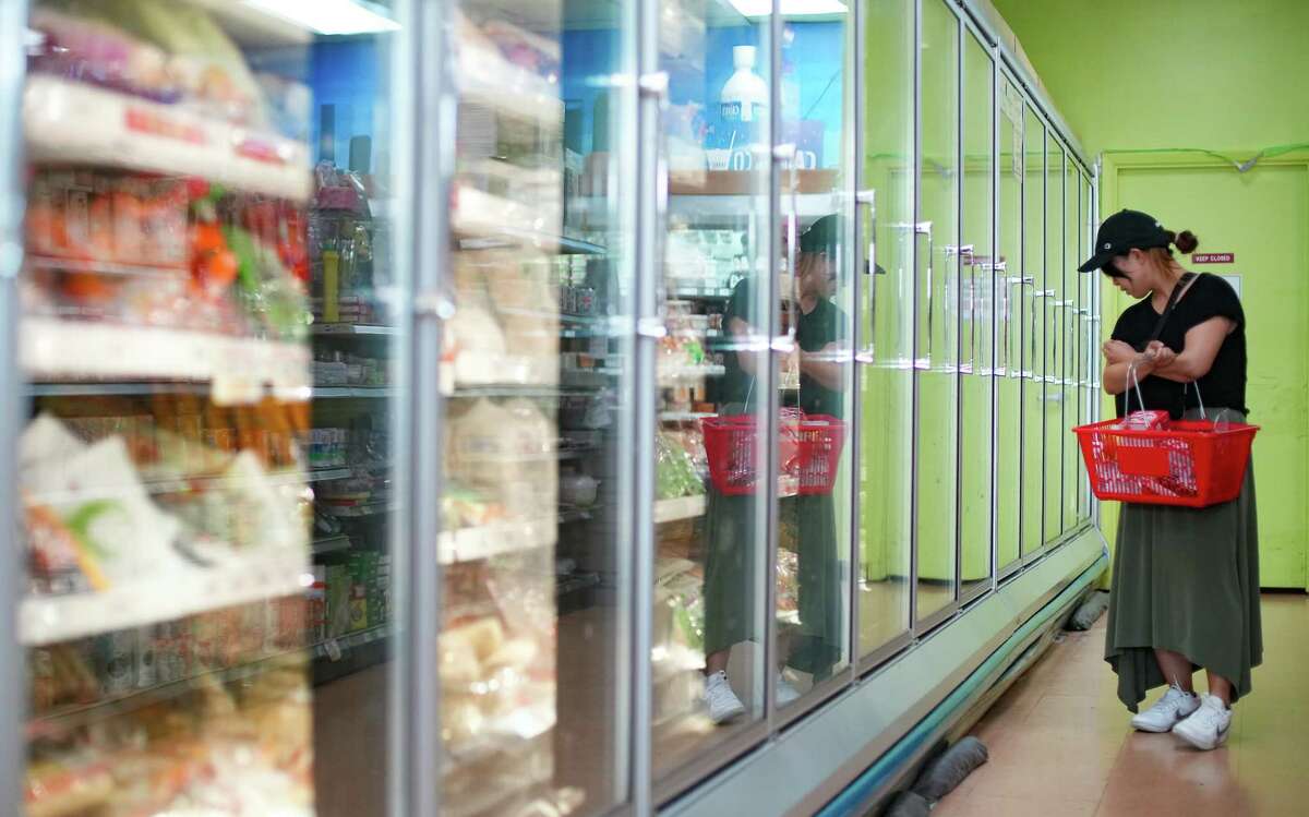 A shopper checks over the freezer options at Daido, a Japanese grocery store in Houston, on Wednesday, Oct. 12, 2022. The strong U.S. dollar is affecting Houston businesses, including importers.