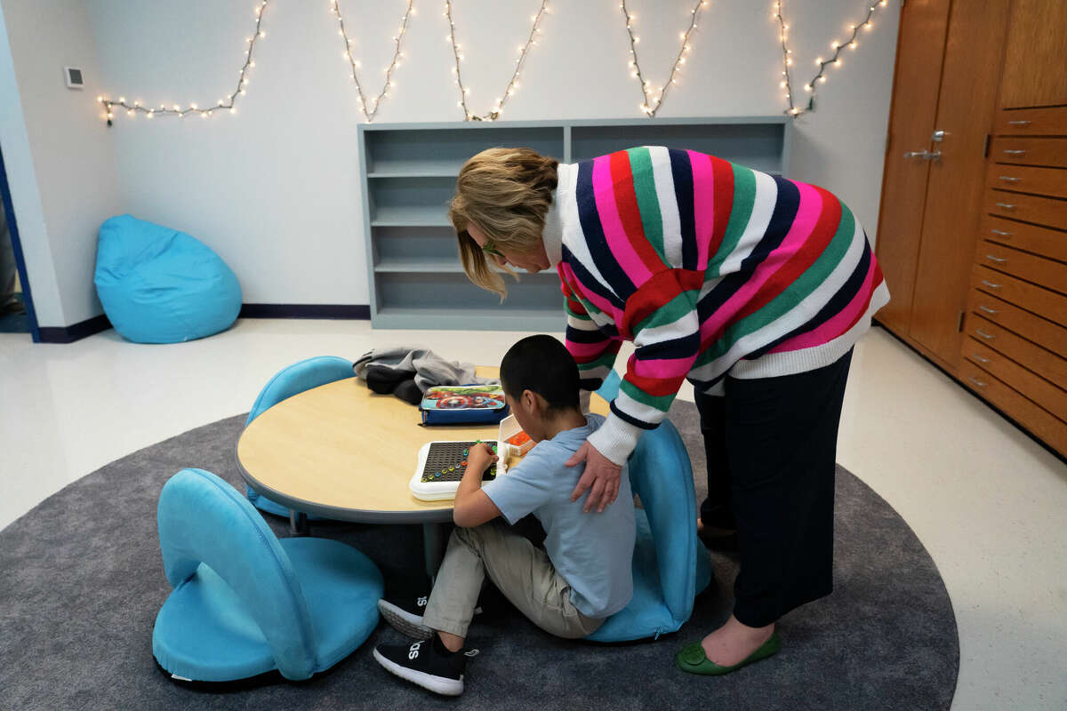 Principal Sally Herrell visits with a student using a light bright in the âchill zoneâ classroom at Clear Creek Intermediate School, Tuesday, March 8, 2022, in Sanger. Sanger Independent School District has taken a holistic approach, beefing up its own resources and partnering with the community, creating one of the best-resourced districts in Texas.
