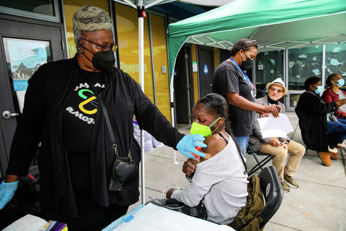New COVID boosters cut infection risk from XBB.1.5 subvariant in half. Umoja Health worker Cassandra Robertson places a Bandaid on the arm of community member Seana McGee after administering a COVID-19 booster shot during a community health fair at Hayes Valley Playground on October 12, 2022, in San Francisco.