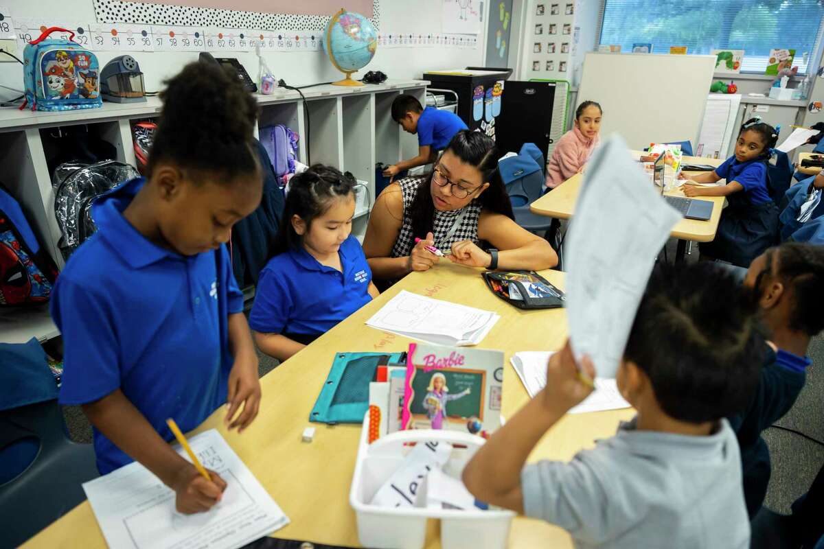 Kindergarten teacher Roxana Sanchez helps her students at Westchase Neighborhood School on Tuesday, Oct. 11, 2022.