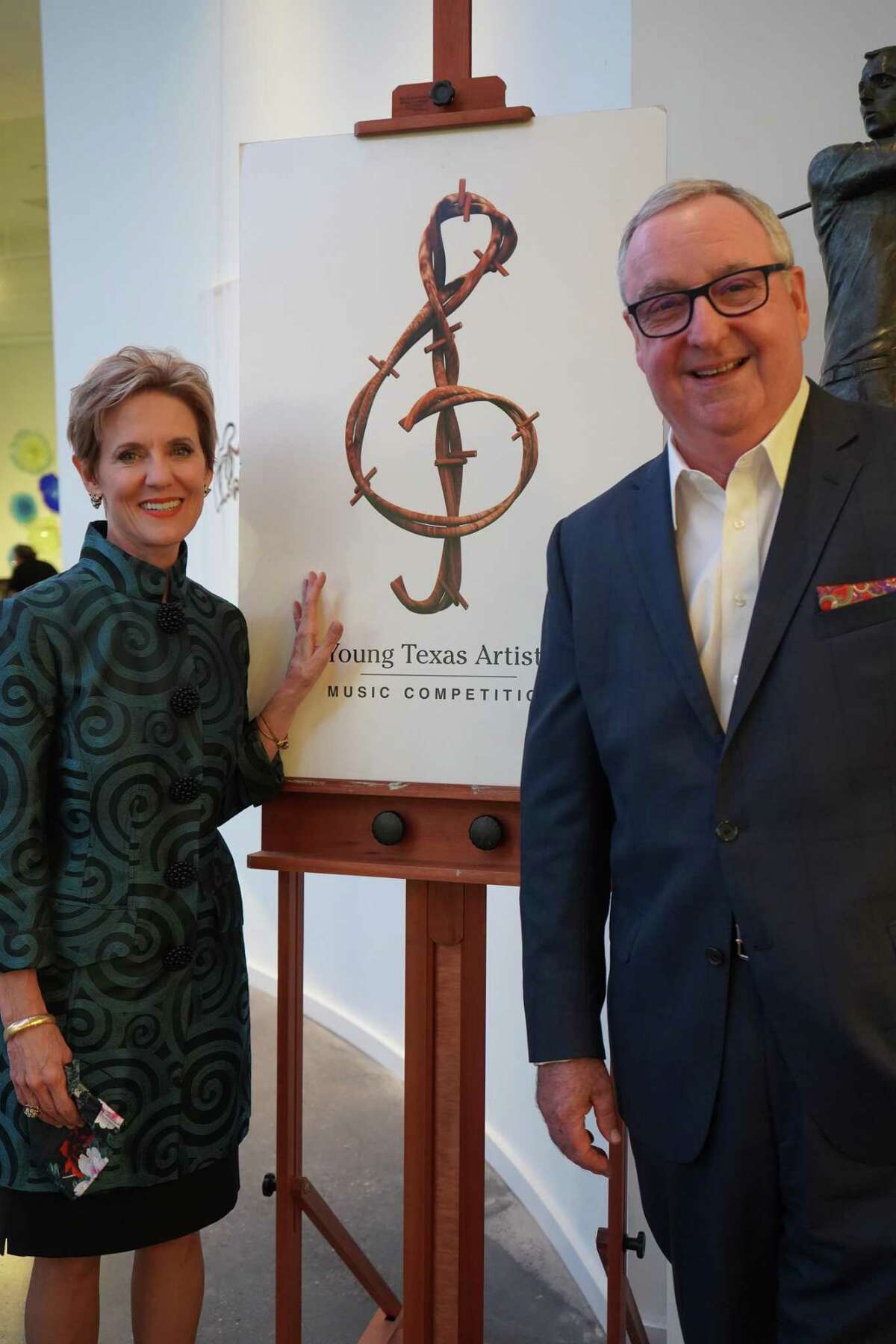 Pictured are Susie Moore Pokorski and Gil Staley with the Young Texas Artists Music Competition logo.