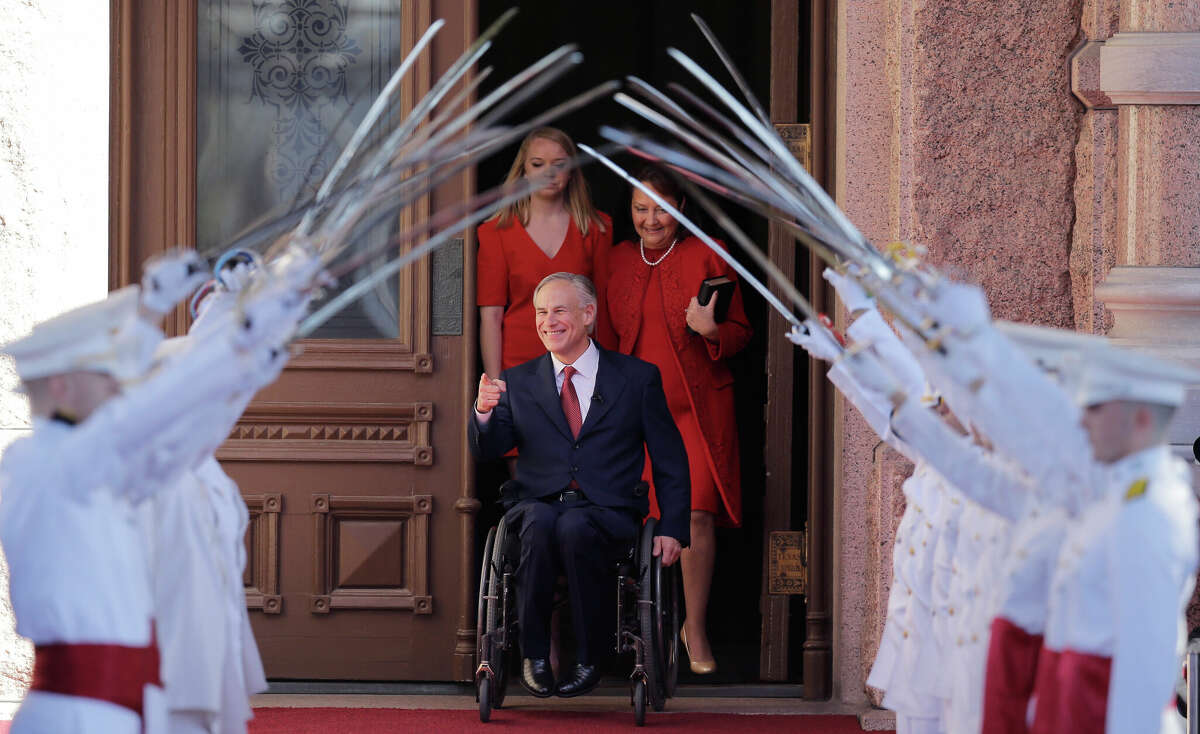 Texas Gov.-elect Greg Abbott, center, arrives for his inauguration with his wife, Cecilia, right, and daughter, Audrey, left, Tuesday, Jan. 20, 2015, in Austin, Texas. Abbott is the first Texas governor to use a wheelchair. (AP Photo/Eric Gay)