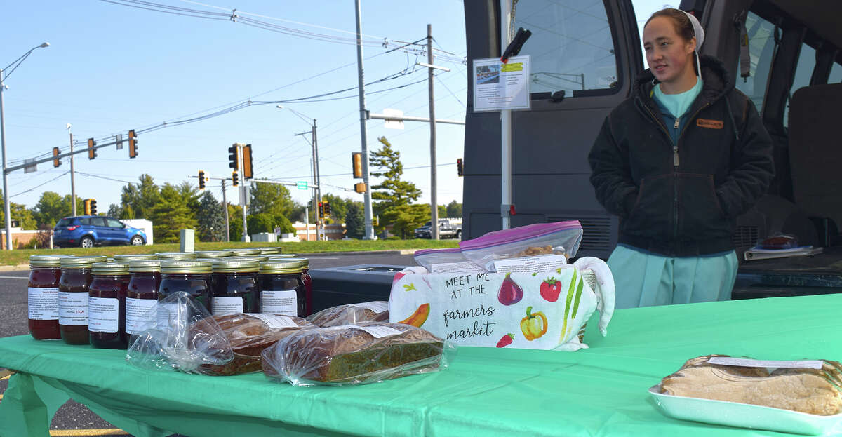 Rhoda Yoder of Roodhouse stands in the parking lot of Pathway Plaza at 1905 W. Morton Ave., ready to sell her family's baked goods and jams at the Jacksonville Farmers Market.