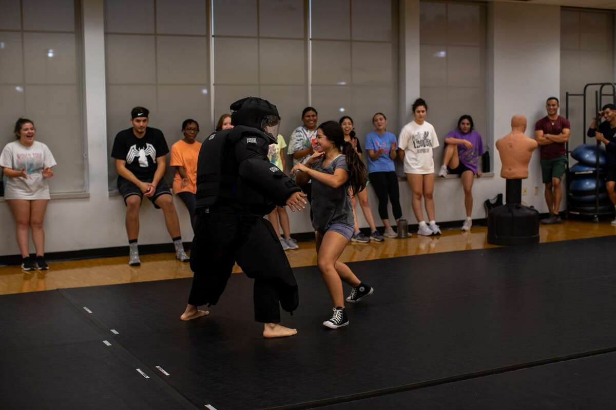 Juan Carlos Martinez simulates a situation where students would need to physically protect themselves during a self-defense class at the University of Texas at San Antonio on Wednesday. (Kaylee Greenlee Beal/Contributor)