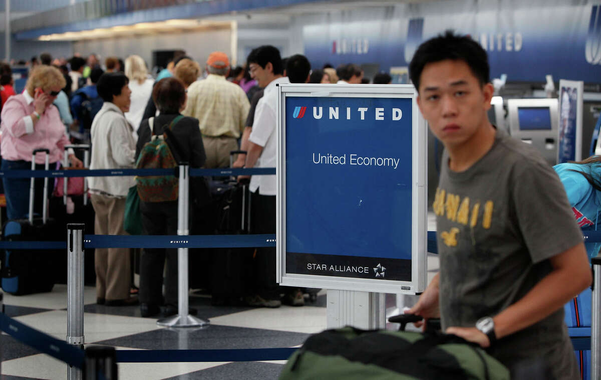 Passengers line up at the United Airlines terminal at O'Hare Airport in July 2009 in Chicago, Illinois.