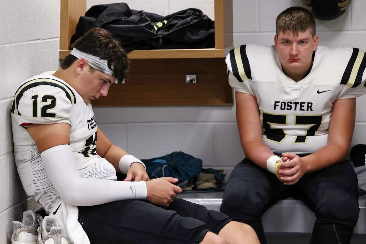 Foster quarterback J.T. Fayard (12) & Chase Hacker (57) wait in the locker room during a lightning delay at a District 10-5A Division I high school football game between the Foster Falcons and the Manvel Mavericks at Freedom Field in Rosharon, TX on Thursday, October 13, 2022.