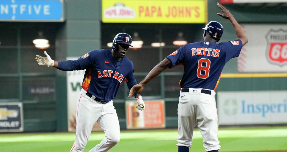 Houston Astros Yordan Alvarez (44) gets a high-five from third base coach Gary Pettis (8) after hitting a 2-run home run off Seattle Mariners starting pitcher Luis Castillo to give the Astros a 3-2 lead in the sixth inning during Game 2 of the American League Division Series at Minute Maid Park on Thursday, Oct. 13, 2022, in Houston.