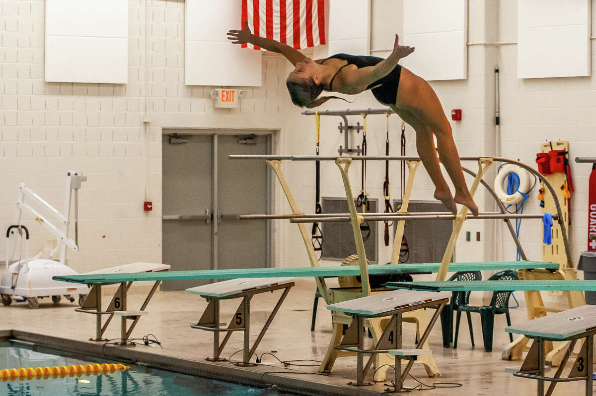 Dow High's Emily Krzciok competes in 1-meter diving during Thursday's home meet against Davison and Mount Pleasant, Oct. 13, 2022.