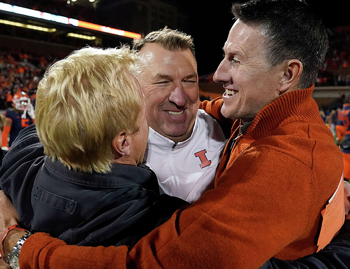 Fighting Illini head coach Bret Bielema is hugged by friends after his team's 9-6 win over Iowa last Saturday in Champaign. Illinois will host Minnesota Saturday in the annual Homecoming Game in Champaign.