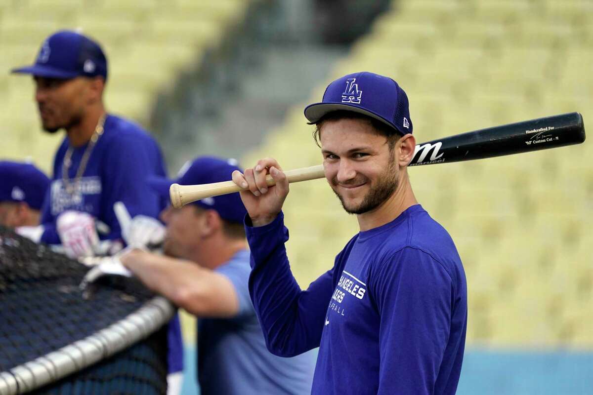 Los Angeles Dodgers' Trea Turner, right, smiles while taking batting practice during a workout in preparation for Game 1 of a baseball NL Division Series, Friday, Oct. 7, 2022, in Los Angeles. The Dodgers will face the winner of the wild-card series between the San Diego Padres and the New York Mets. (AP Photo/Marcio Jose Sanchez)