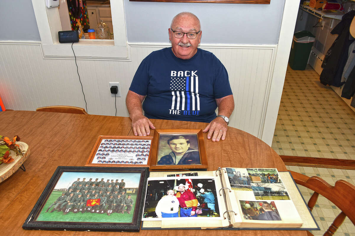 Tom Cisne displays photos from his long and varied life and careers.
