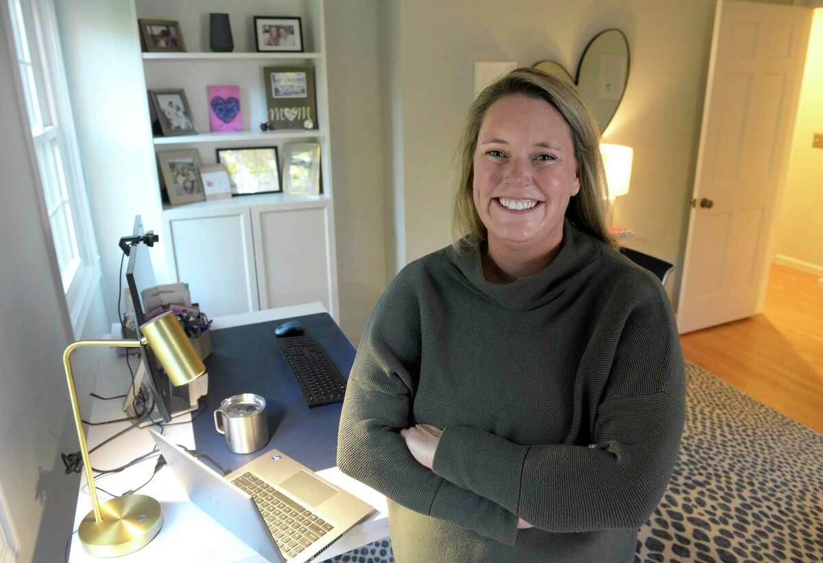 Jenna Clay, a vice president at Stamford-based Synchrony, stands in her home office in Ridgefield on Friday, Oct. 14, 2022. 