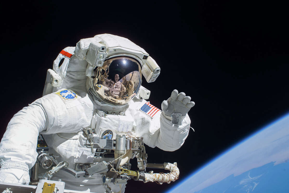 Astronaut Joseph R. Tanner, STS-115 mission specialist, waves towards the digital still camera of his spacewalk colleague, Astronaut Heidemarie M. Stefanyshyn-Piper, as the two share extravehicular activity (EVA) duties during the first of three scheduled spacewalks.  STS-115 astronauts and Expedition 13 crew members are combining efforts this week to resume construction of the International Space Station.