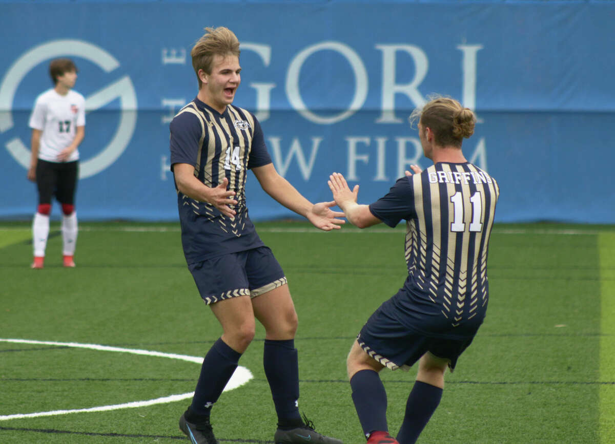 Aaron Broadwater, left, is greeted by teammate Owen Terrell, right, after Broadwater's first goal against Staunton on Friday at Norman Lewis Field in the Class 1A Roxana Regional Championship. Broadwater scored two goals in the Griffins 4-1 win. 