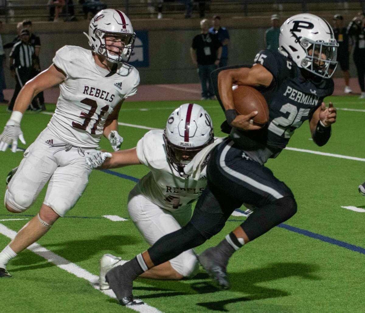 Permian quarterback Rodney Hall is chased out of the pocket by Trace Low and a diving tackle by Esus Robledo 09/14/2022 at Ratliff Stadium. Tim Fischer/Reporter-Telegram