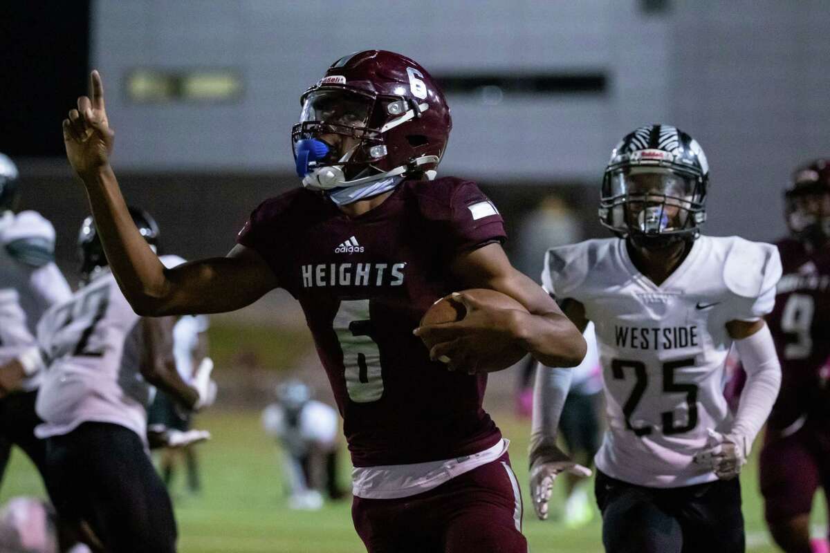 Heights quarterback Allen Rainey (6) runs for a touchdown late in a high school football game between Heights and Westside Friday, Oct 14, 2022, in Houston.