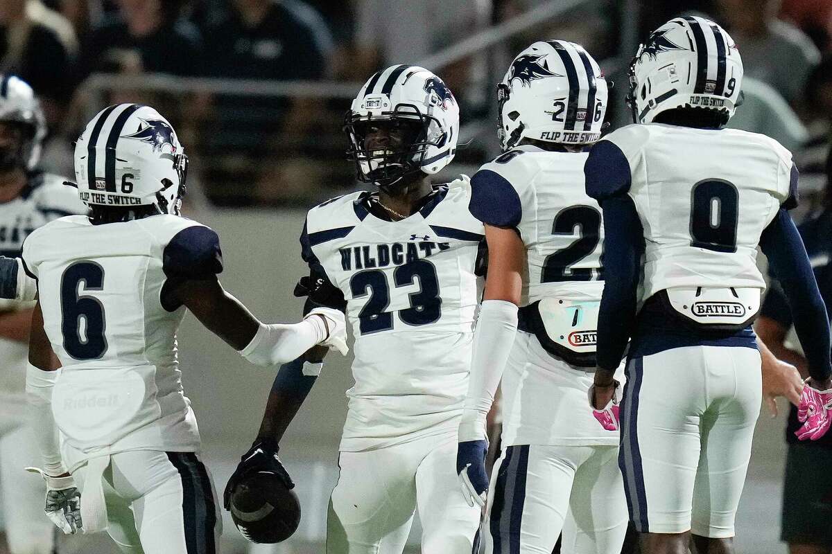 Tomball Memorial defensive back Matthew Bess (23) celebrates his interception with R'mon Williams (6) during the first half of a high school football game against Tomball, Friday, Oct. 14, 2022, in Tomball.