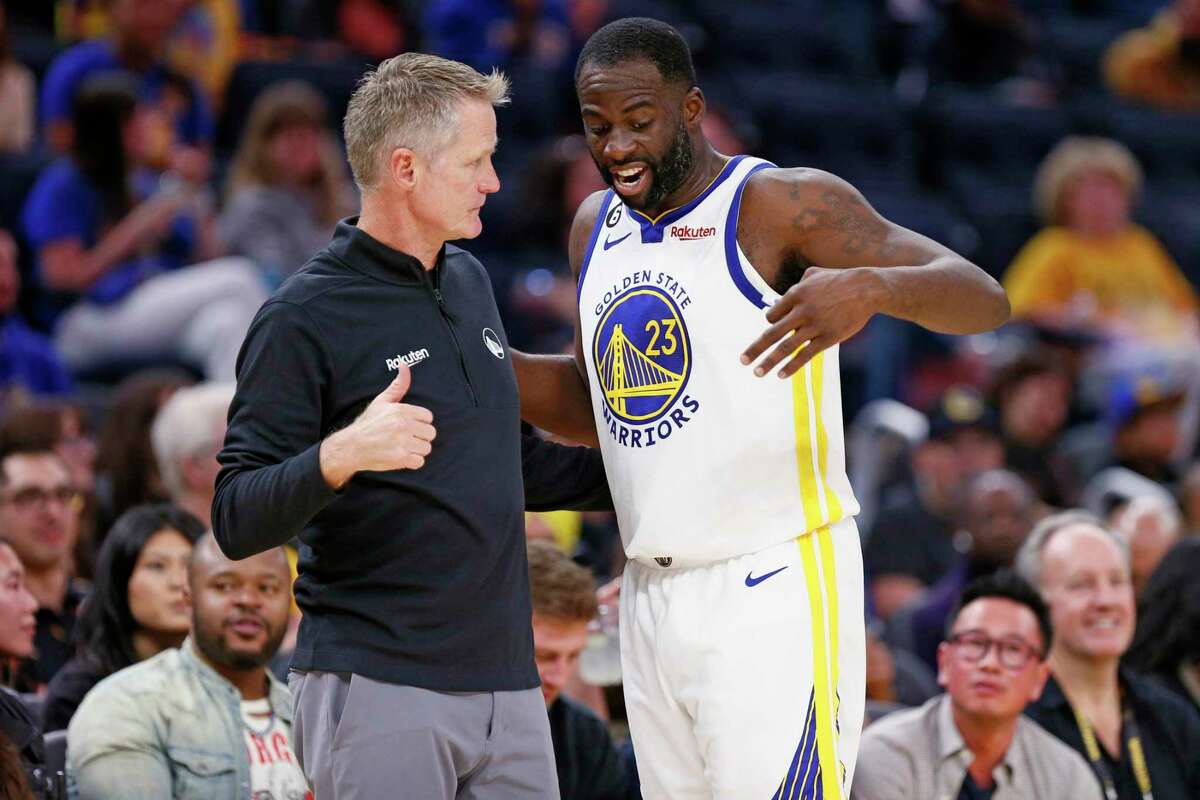 Golden State Warriors head coach Steve Kerr chats with Warriors forward Draymond Green (23) in the first half of an NBA game against the Denver Nuggets at Chase Center in San Francisco, Calif., Friday, Oct. 14, 2022.