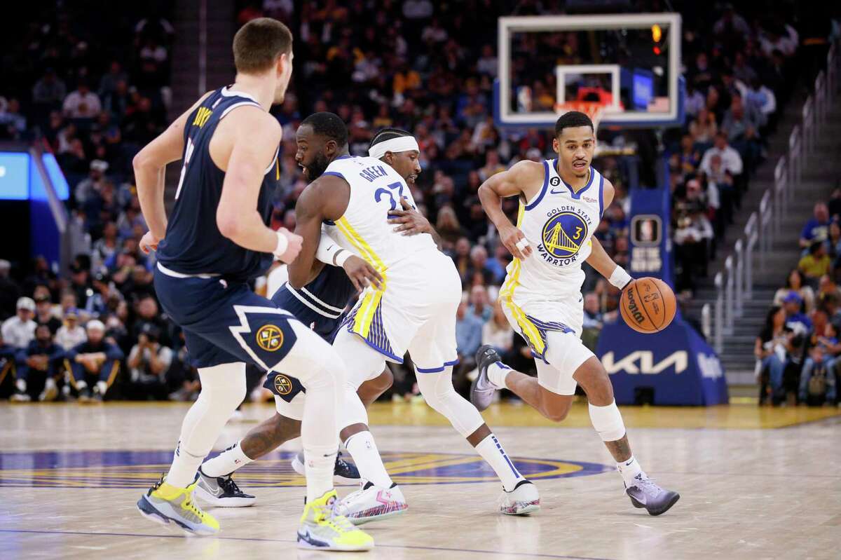Golden State Warriors forward Draymond Green (23) sets up a screen for Warriors guard Jordan Poole (3) in the first half of an NBA game against the Denver Nuggets at Chase Center in San Francisco, Calif., Friday, Oct. 14, 2022.