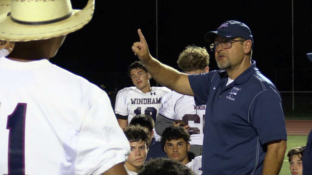 Windham coach Randall Prose speaks with his team after a 56-14 victory over E.O. Smith in Storrs, CT on Thurday, Sept. 8, 2022.