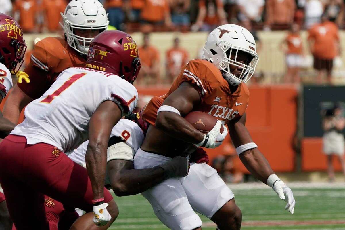 Texas running back Bijan Robinson (5) is hit by Iowa State defensive end Will McDonald IV (9) during the first half of an NCAA college football game, Saturday, Oct. 15, 2022, in Austin, Texas. (AP Photo/Eric Gay)
