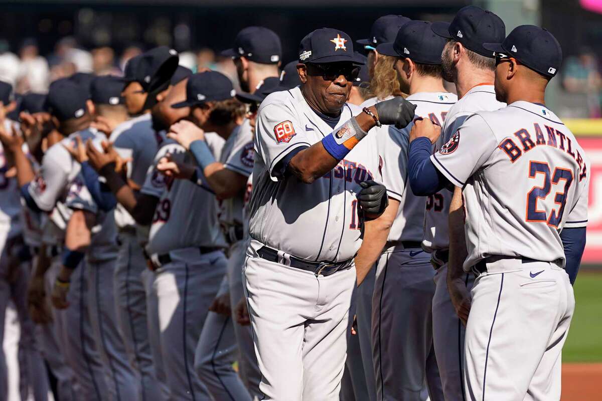 Houston Astros manager Dusty Baker Jr. fist bumps Michael Brantley as he is introduced before Game 3 of the American League Division Series against the Seattle Mariners on Saturday, Oct. 15, 2022, in Seattle.
