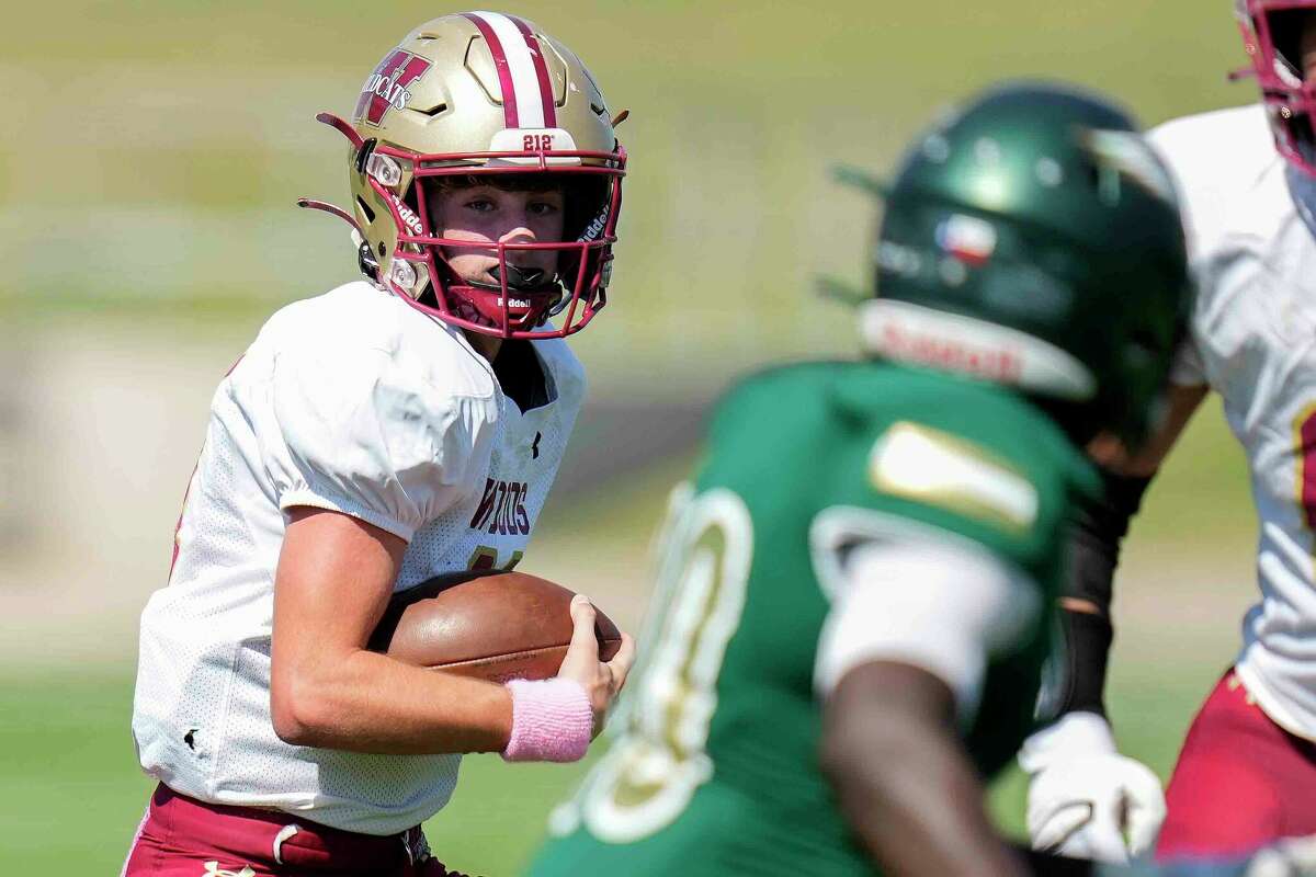 Cy-Woods quarterback Aiden Horton, left, scrambles during the first half of a high school football game against Cy-Falls, Saturday, Oct. 15, 2022, in Houston.