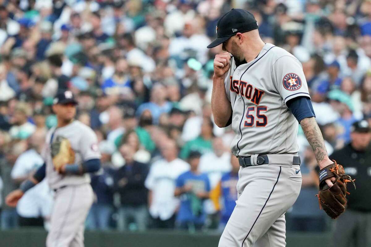Houston Astros relief pitcher Ryan Pressly walks back to the mound after striking out Seattle Mariners designated hitter Carlos Santana during the ninth inning of Game 3 of the American League Division Series on Saturday, Oct. 15, 2022, in Seattle.