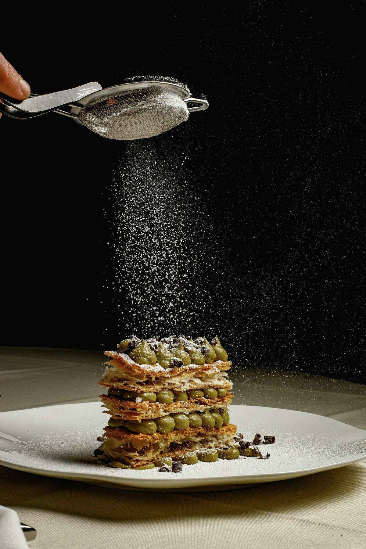 Putting the finishing touches on a millefoglie al pistacchio dessert at Materia Ristorante in Bantam