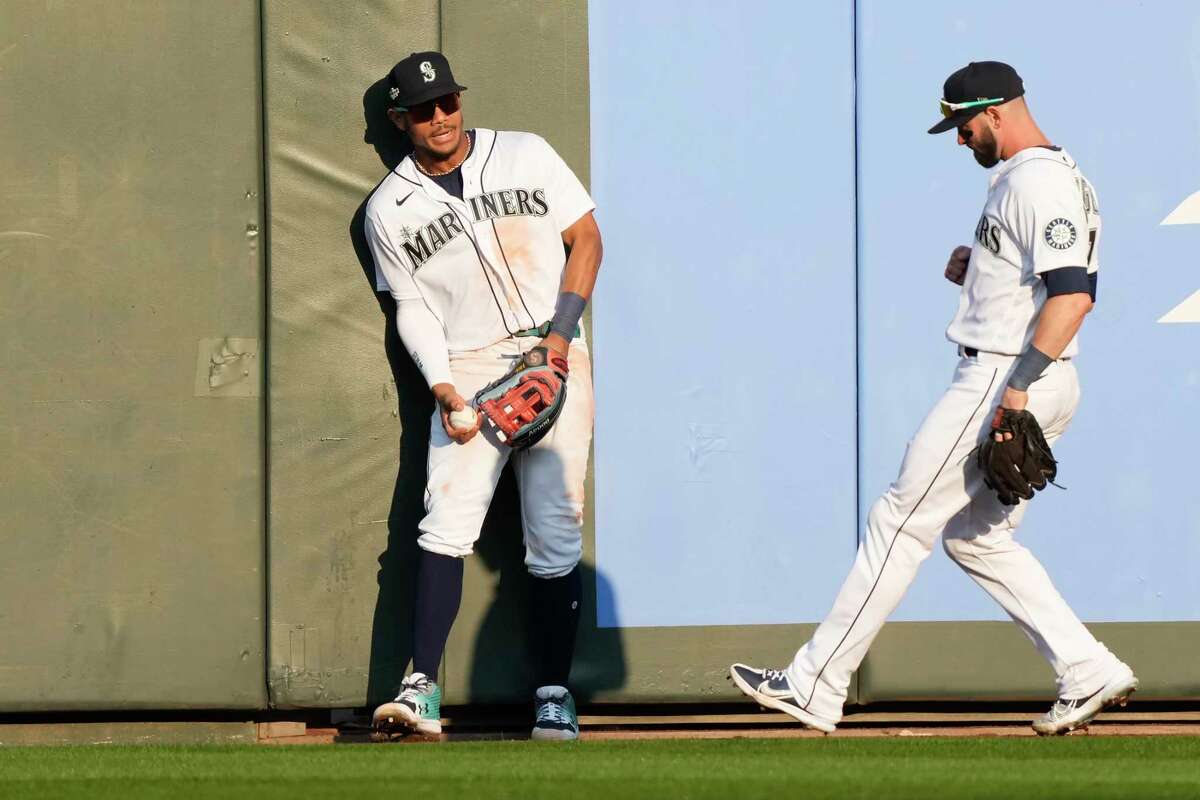 Seattle Mariners center fielder Julio Rodriguez (44) backs into the outfield wall after catching a deep fly ball by Houston Astros left fielder Yordan Alvarez during the 10th inning of Game 3 of the American League Division Series on Saturday, Oct. 15, 2022, in Seattle.